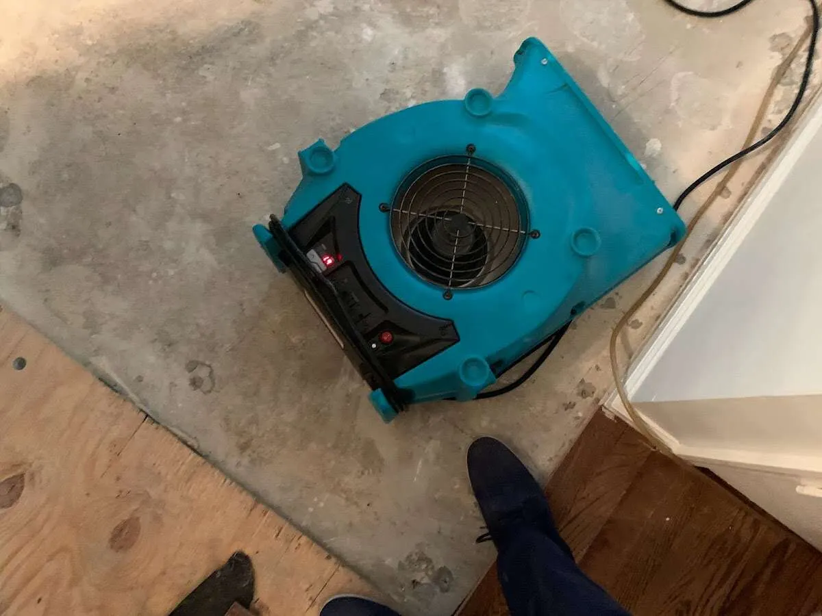 Air mover drying subfloor during Leak Detection & Repair in Yuba City